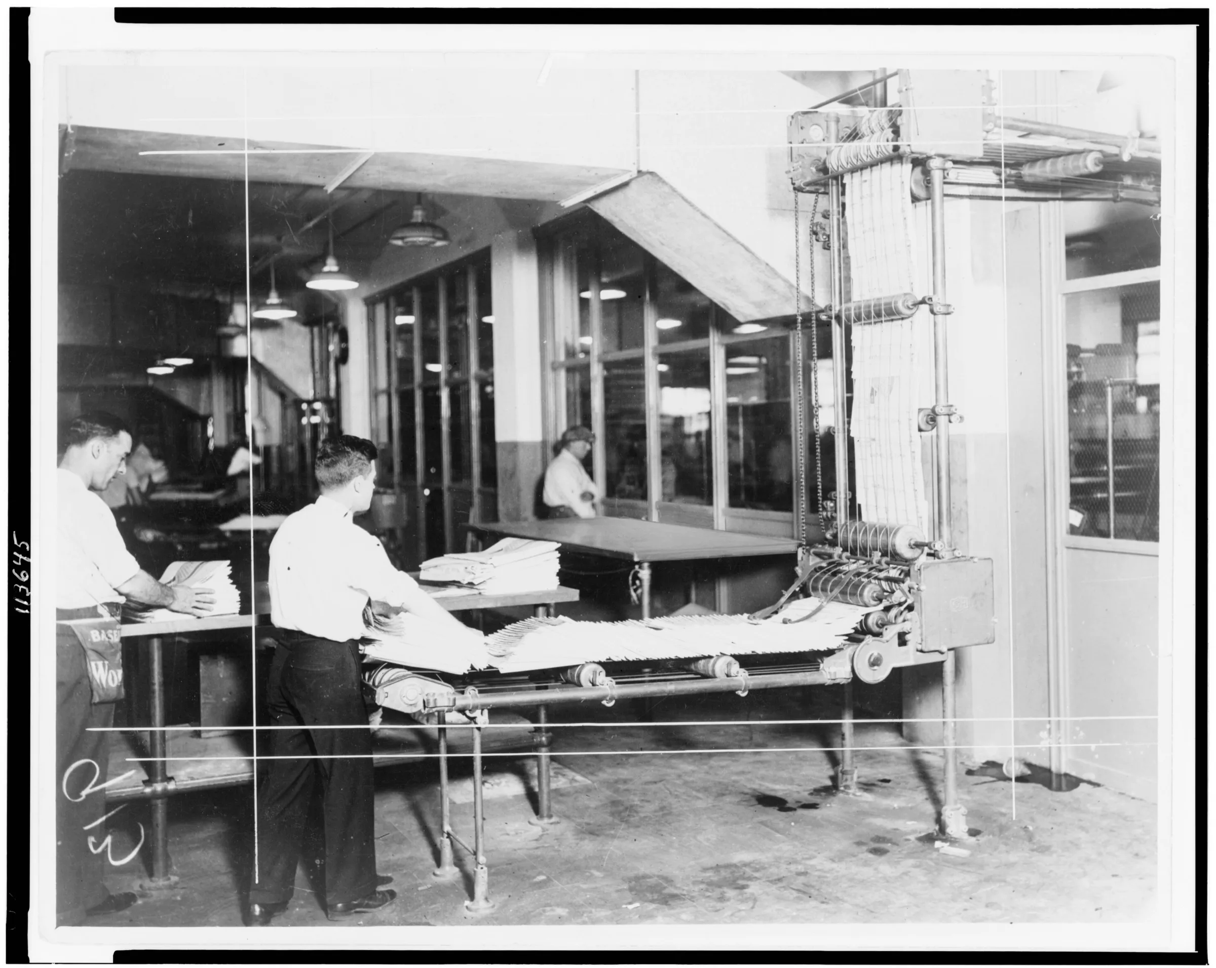 A 1930s newspaper delivery room, with workers stacking freshly printed papers